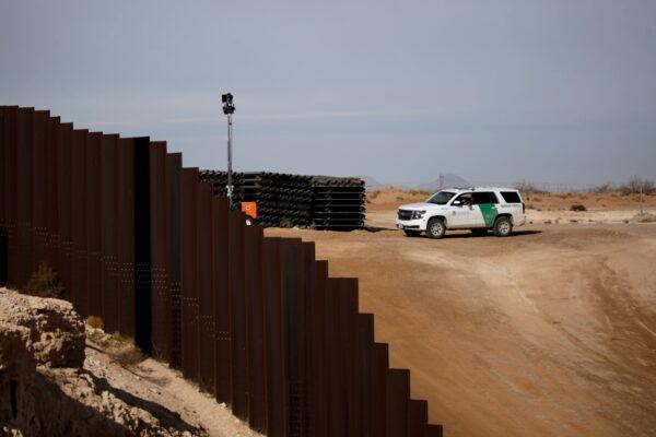 A U.S. Border Patrol agent patrols near the border wall in Sunland Park, New Mexico, as pictured from the Mexican side of the border in Ciudad Juarez, on February 12, 2021. (Jose Luis Gonzalez/Reuters)