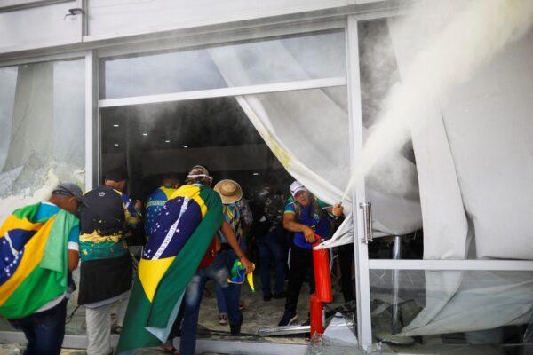 Supporters of Brazil's former President Jair Bolsonaro break into a building during a demonstration against President Luiz Inácio Lula da Silva in Brasilia, Brazil, on Dec. 8, 2023. (Adriano Machado/Reuters)
