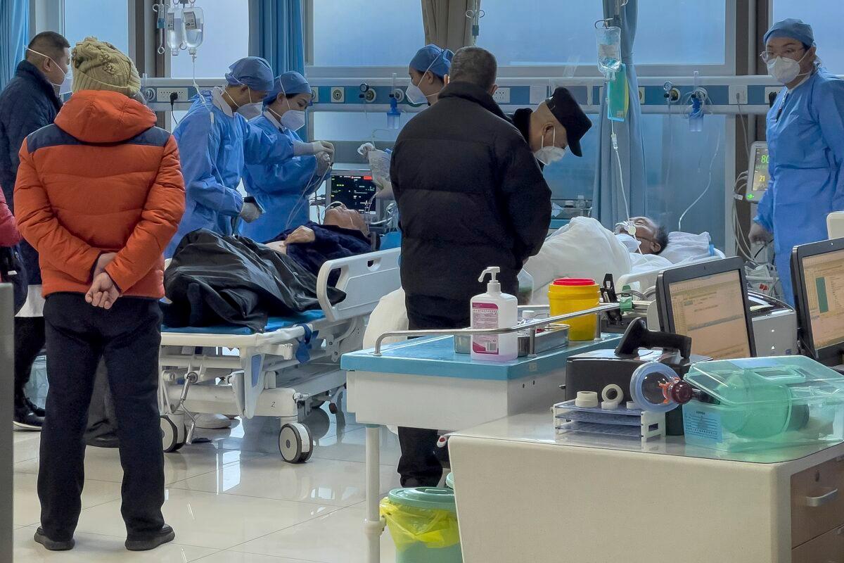 Medical workers and elderly patients at an emergency hall in a hospital in Beijing on Jan. 7, 2023. (Andy Wong/AP Photo)