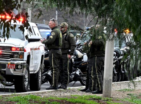 Riverside County Sheriff's stand at the corner of Golden West Avenue and Condor Drive in Jurupa Valley, Calif., on Dec. 29, 2022. (Will Lester/The Orange County Register via AP)