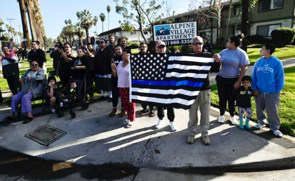 Residents line up in Riverside, Calif., to honor slain Riverside County Sheriff's deputy, Isaiah Cordero as the procession makes its way from the mortuary to the church for his funeral on Jan. 6, 2023. (Watchara Phomicinda/The Orange County Register via AP)