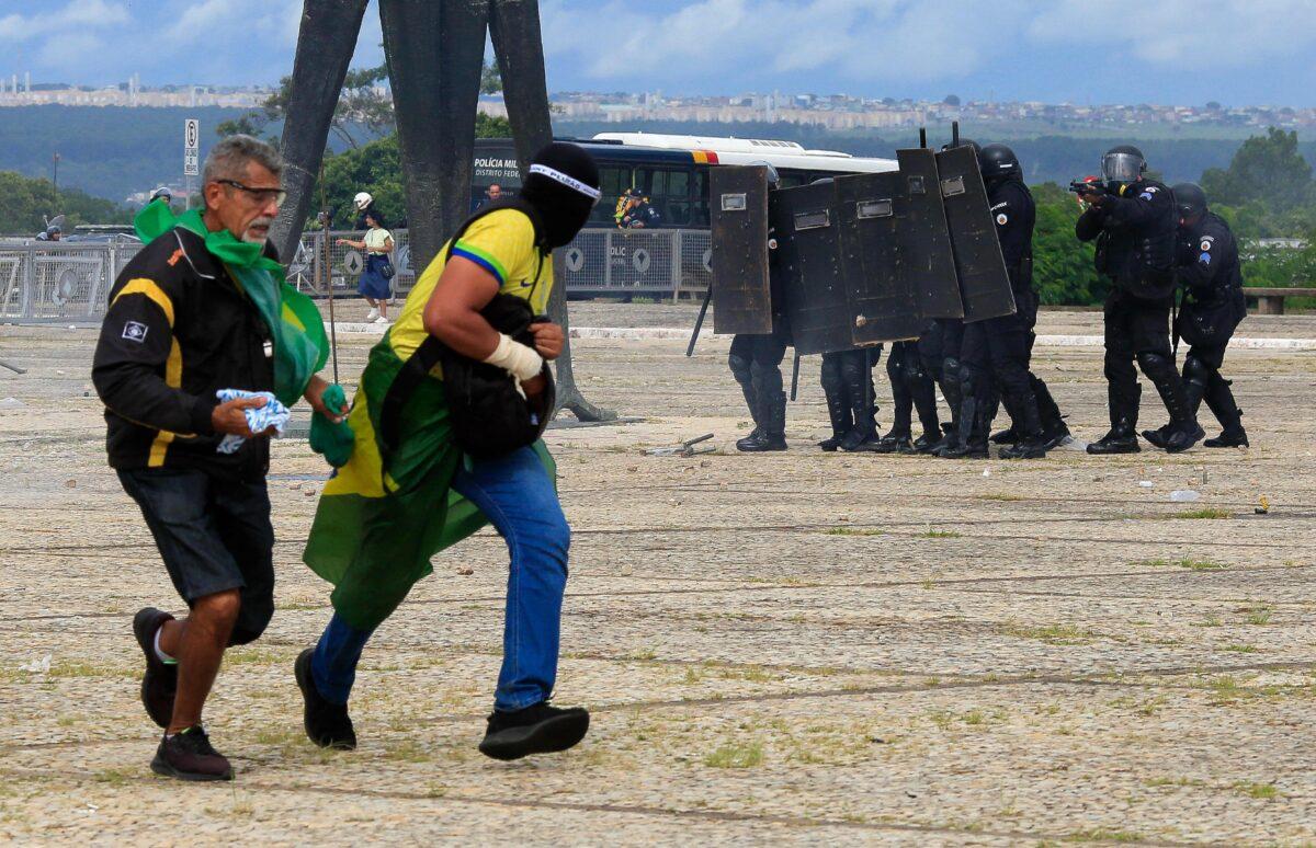 Security forces confront supporters of Brazilian former President Jair Bolsonaro as they breach the Planalto Presidential Palace in Brasilia on Jan. 8, 2023. (Sergio Lima/AFP via Getty Images)