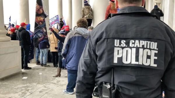A U.S. Capitol Police officer monitors the crowd atop the east Rotunda steps on Jan. 6, 2021. (Bobby Powell/Special to The Epoch Times)