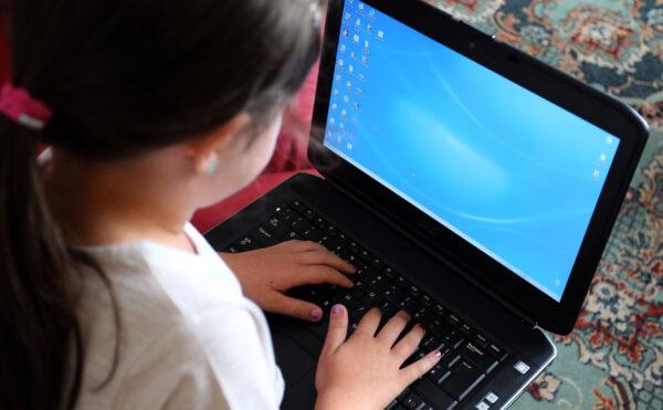 A child using a computer in an undated file photo. (Peter Byrne/PA Media)