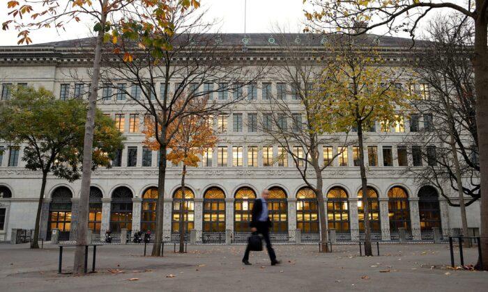 A man walks past the Swiss National Bank building in Zurich, on Oct. 31, 2013. (Arnd Wiegmann/Reuters)