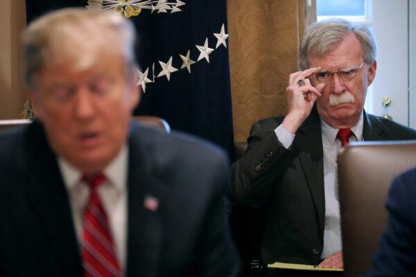 Then-national security adviser John Bolton (R) listens to then-President Donald Trump speak to reporters during a meeting of his cabinet in the Cabinet Room at the White House on Feb. 12, 2019. (Chip Somodevilla/Getty Images)