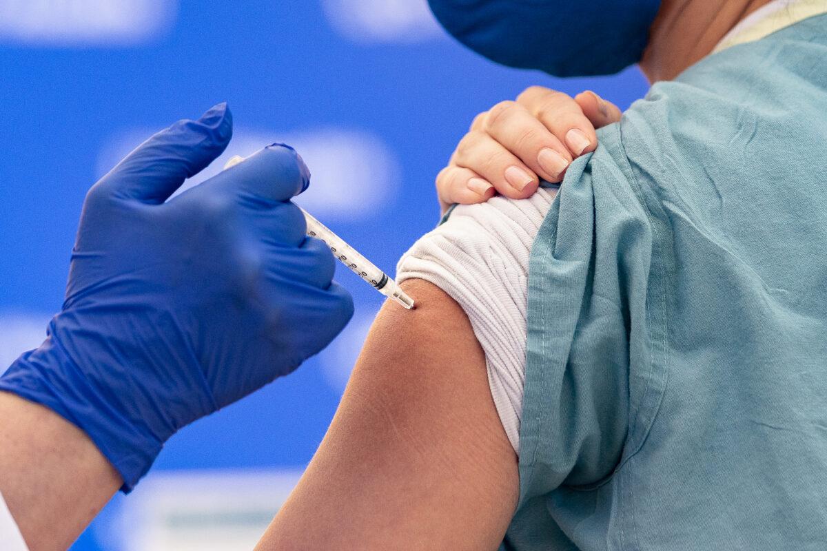 A nurse recieves a COVID-19 vaccination in Orange, Calif., on Dec. 16, 2020. (John Fredricks/The Epoch Times)