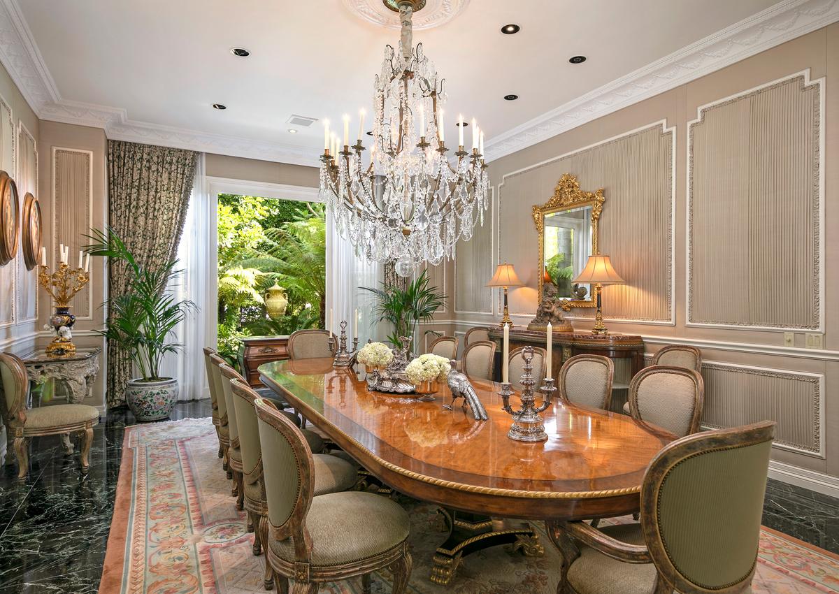 Fit for royalty, the formal dining room has seating for 16 and provides a great view of the estate's lush grounds. (Courtesy of Jade Mills Estates)