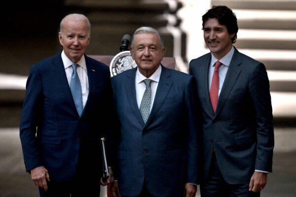 (L-R) U.S. President Joe Biden, Mexican President Andres Manuel Lopez Obrador, and Canadian Prime Minister Justin Trudeau pose for pictures after speaking to the press during the 10th North American Leaders Summit at the National Palace in Mexico City on Jan. 10, 2023. (Nicolas Asfouri/AFP via Getty Images)