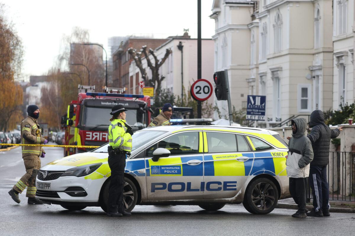 Firefighters and police at the scene of a burst water main that caused flooding on Belsize Road in Camden in London on Dec. 17, 2022. (Hollie Adams/Getty Images)
