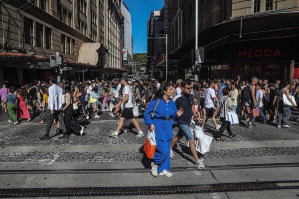People walk along George Street on Boxing Day in Sydney, Australia on Dec. 26, 2022. (Photo by Roni Bintang/Getty Images)