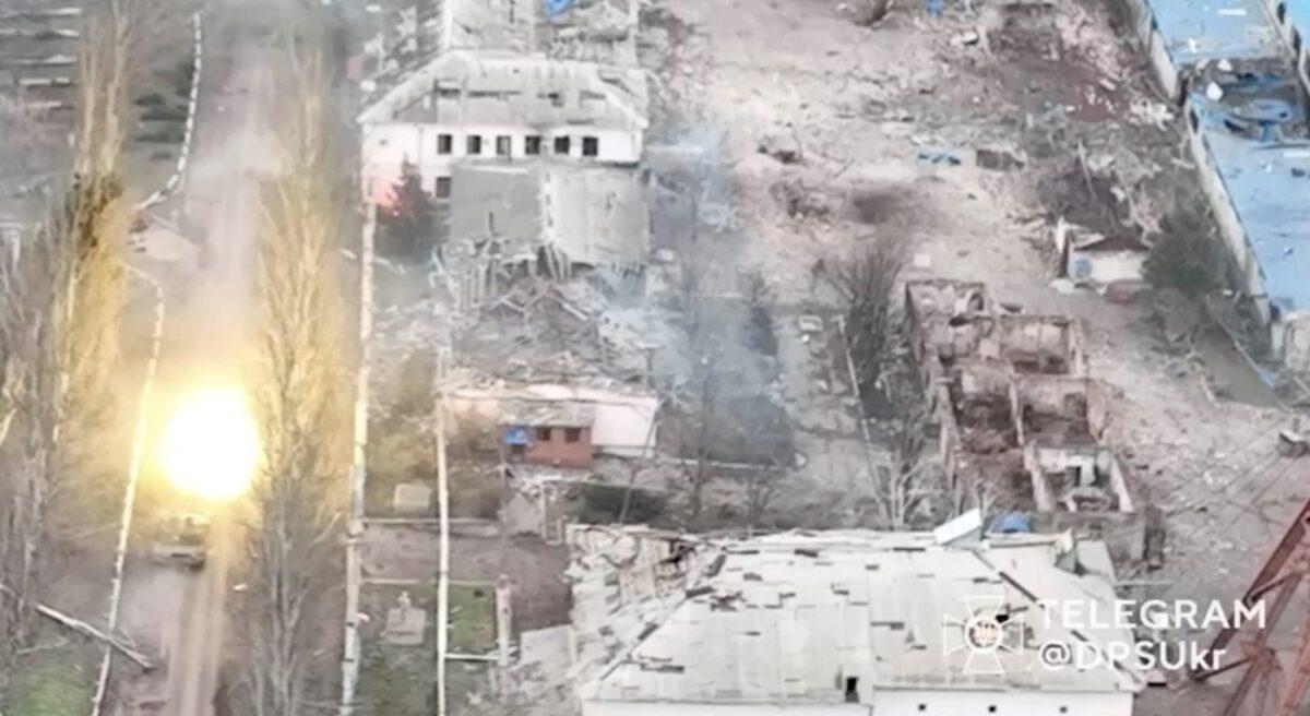 A tank fires a round amid Russia's attack on Ukraine in Soledar, Donetsk region, in this screen grab released on Jan. 8, 2023. (State Border Guard Service of Ukraine/via Reuters)