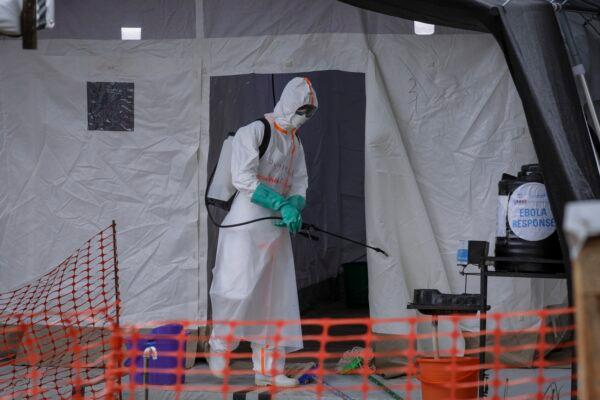 A medical worker disinfects a tent used for suspected Ebola victims inside the Ebola isolation center of Madudu Health Center III, in the village of Madudu, in the Mubende district of Uganda on Nov. 1, 2022. (Hajarah Nalwadda/AP Photo)