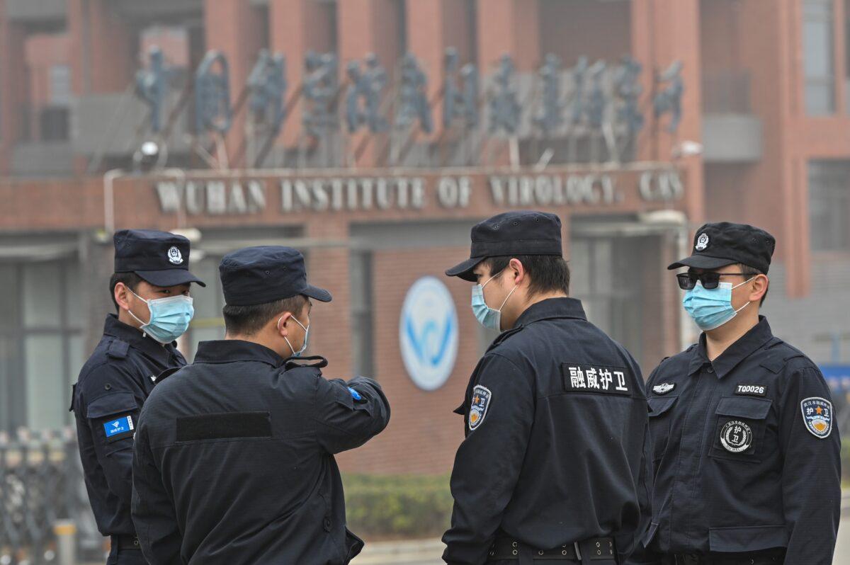 Security personnel stand guard outside the Wuhan Institute of Virology as members of the World Health Organization (WHO) team investigating the origins of the COVID-19 coronavirus visit the institute in Wuhan, in China's Hubei Province, on Feb. 3, 2021. (Hector Retamal/AFP via Getty Images)