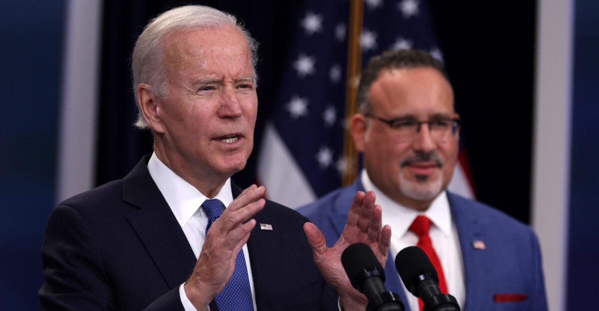 President Joe Biden speaks on a previous student debt relief scheme as Education Secretary Miguel Cardona looks on in Washington in an undated file photo. (Alex Wong/ Getty Images)