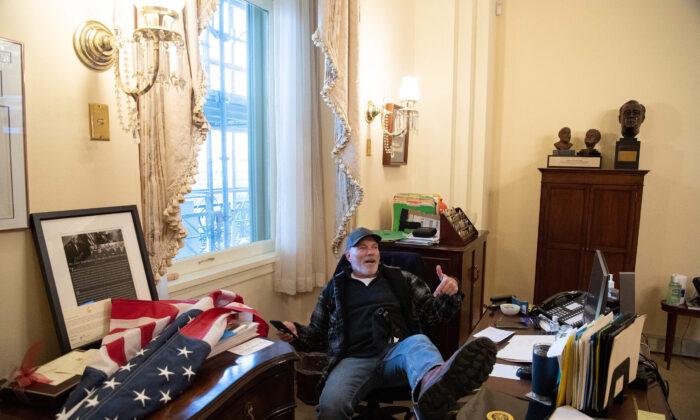 Richard Barnett, a supporter of then-U.S. President Donald Trump sits inside the office of U.S. House Speaker Nancy Pelosi on Jan. 6, 2021. (Saul Loeb/AFP via Getty Images)