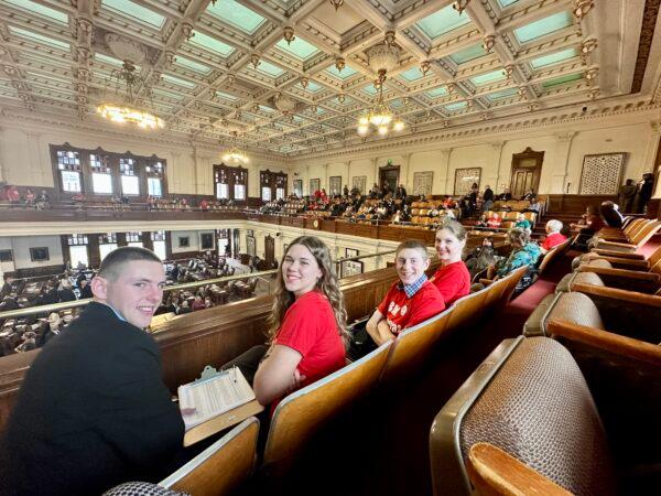 Daniel Southerland (L), Grace Bradley (2L), Joshua Southerland (2R), and Hannah Southerland (R), members of the Ellis County Young Republicans, visited the legislative chambers in Austin, Texas, on Jan. 11 to protest against the Republican-led House trend of awarding chairmanships of committees to Democrats. (Darlene McCormick Sanchez/The Epoch Times)