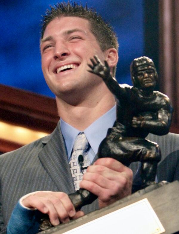 Florida quarterback Tim Tebow holds up the Heisman Trophy after winning the award in New York on Dec. 8, 2007. (Kelly Kline/AP Photo)