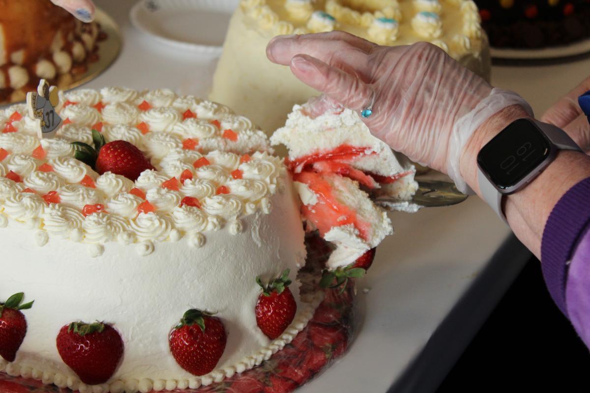 The first slice of a strawberry-decorated angel food cake. (Courtesy of the PA Dept. of Agriculture)