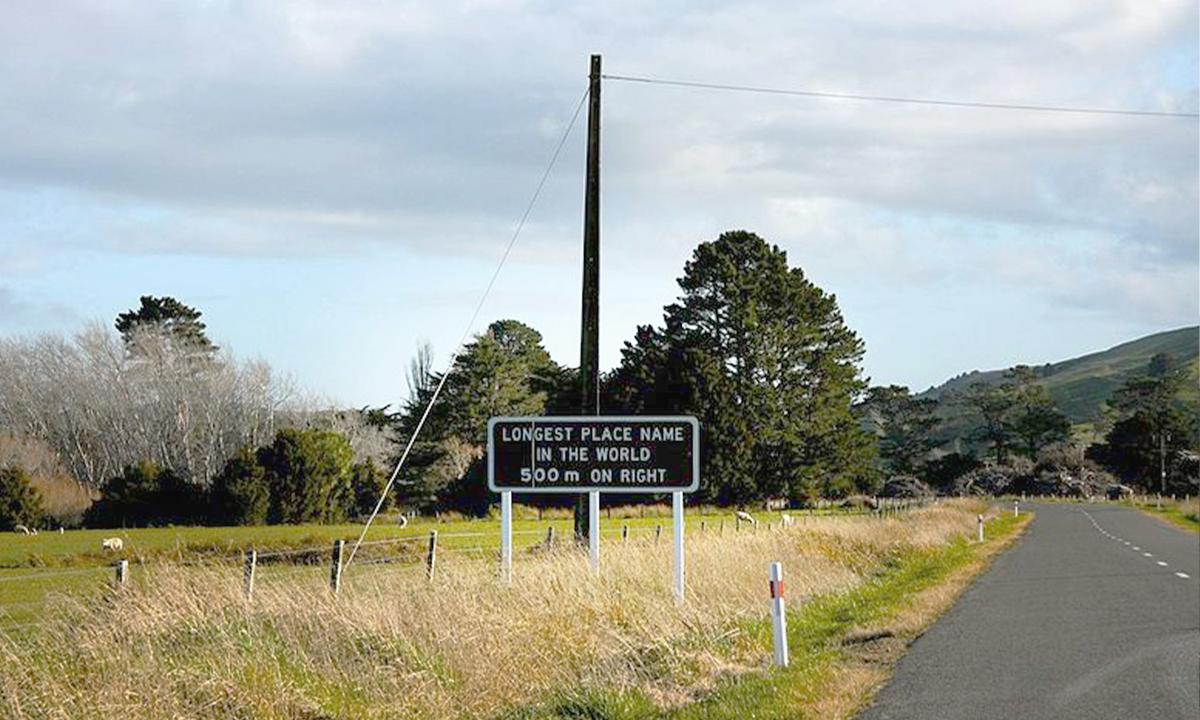 The road sign leading up to the place with the longest name in the world. This image was cropped and color corrected. (<a href="https://commons.wikimedia.org/wiki/File:The_longest_place_name_in_the_world_-_6780300207.jpg">itravelNZ</a>/CC BY 2.0)