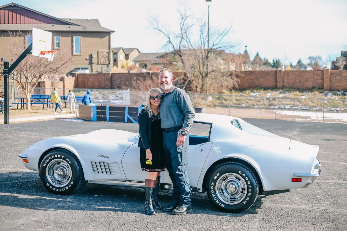 John Coppin and his wife, Tina, stand in front of his newly won 1972 Corvette Stingray. (Courtesy of DrivenBrands)