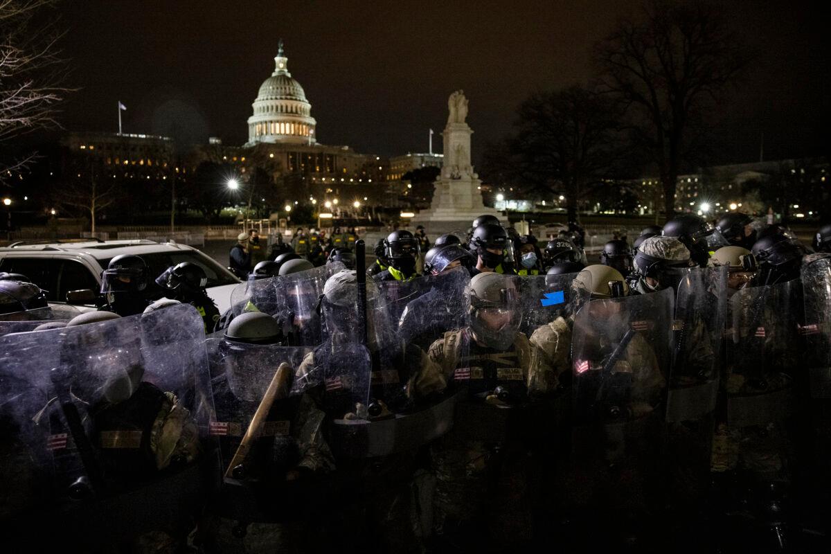 Members of the National Guard and D.C. Metropolitan Police Department stand guard to keep demonstrators away from the U.S. Capitol on Jan. 6, 2021. (Samuel Corum/Getty Images)