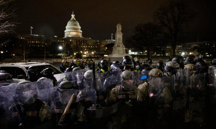 Members of the National Guard and the Washington police stand guard to keep demonstrators away from the U.S. Capitol on Jan. 6, 2021. (Samuel Corum/Getty Images)