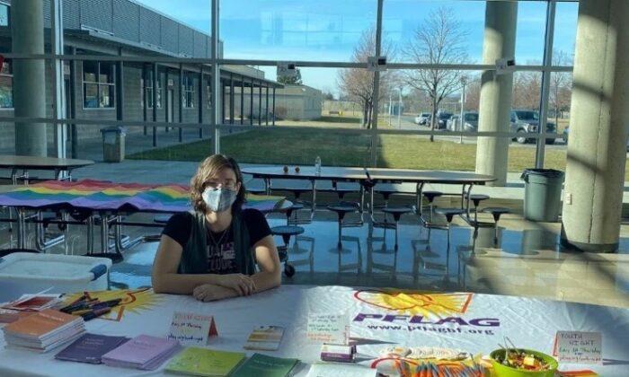 A volunteer staffs an information table at the Hanford High School Equity Summit in Richland, Wash., on Feb. 5, 2022. (Courtesy of PFLAG Benton Franklin)