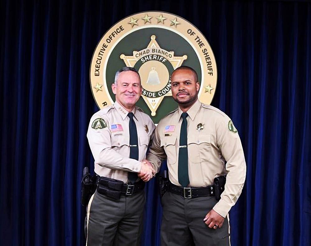 In this undated photo provided by the Riverside County Sheriff, Deputy Darnell Calhoun (R), poses with Riverside County Sheriff Chad Bianco (L) in Riverside, Calif. (Courtesy Riverside County Sheriff)