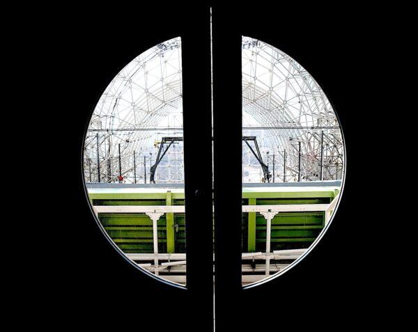 An experimental biome studying water flow lies just beyond the circular window door to the Landscape Evolution Observatory at Biosphere 2 on Jan. 11, 2023. (Allan Stein/The Epoch Times)