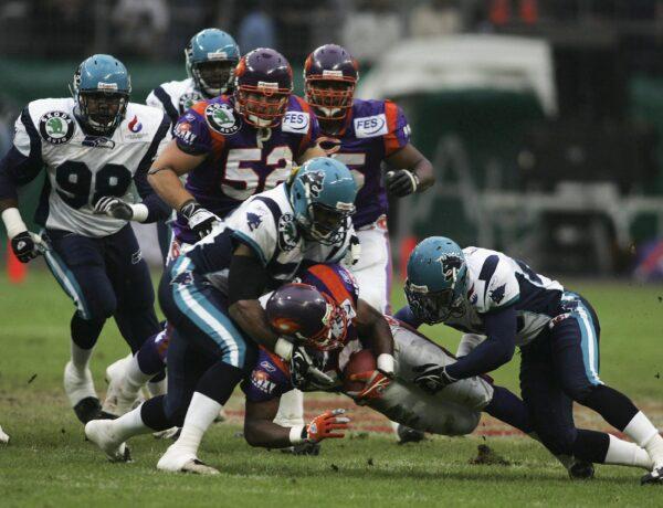 Nick McNeil (L) and Eric Crouch of Hamburg Sea Devils tackle Ahmaad Galloway of Frankfurt Galaxy during the NFL Europe match at the Waldstadion in Frankfurt, Germany on April 23, 2005. (Ralph Orlowski/Bongarts/Getty Images)