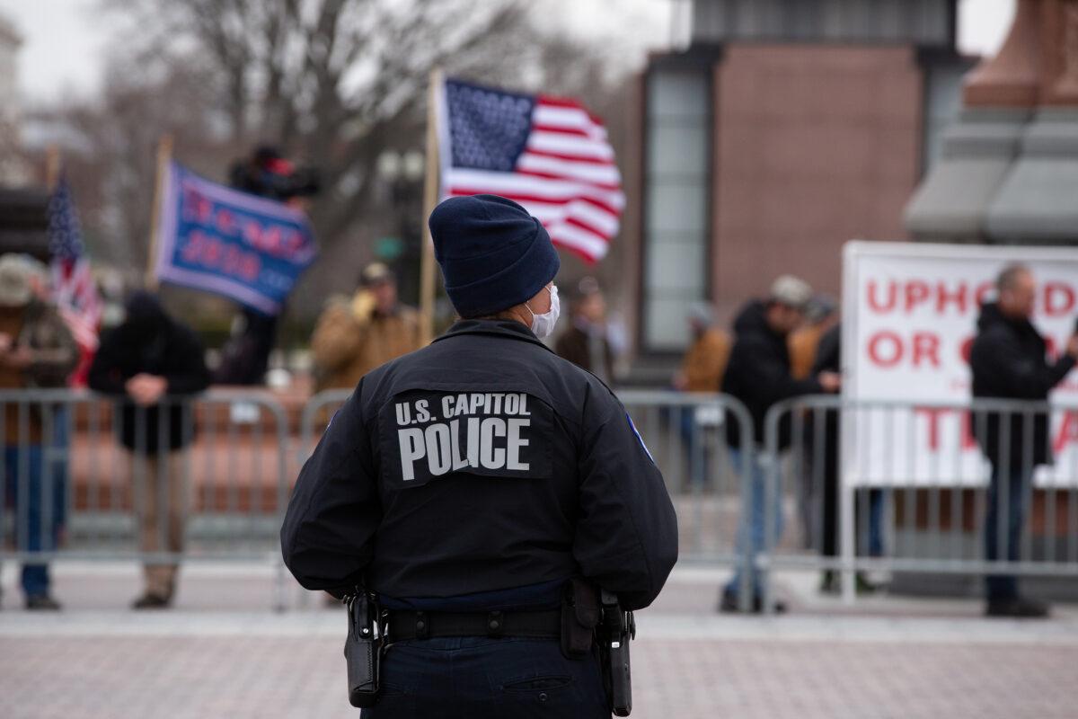 A Capitol Police officer watches supporters of U.S. President Donald Trump gather outside the U.S. Capitol on January 6, 2021. (Cheriss May/Getty Images)