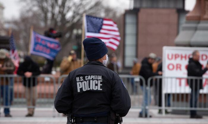 A Capitol Police officer watches supporters of U.S. President Donald Trump gather outside the U.S. Capitol on January 6, 2021. (Cheriss May/Getty Images)