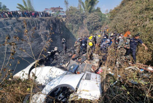 Rescue teams work to retrieve bodies at the crash site of an aircraft carrying 72 people in Pokhara in western Nepal on Jan. 15, 2023. (Bijay Neupane/Handout via Reuters)