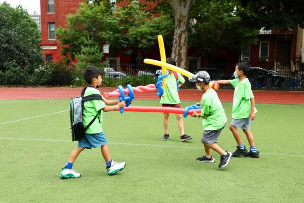 Children and families play yard games at The Children's Place in New York City on July 26, 2022. (Arturo Holmes/Getty Images for The Children's Place, Inc.)