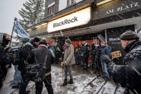 Young Socialists Switzerland (JUSO) activists take part in a protest against U.S. investment company BlackRock calling for a climate tax on the rich, on the eve of the WEF annual meeting in Davos, on Jan. 15, 2022. (Fabrice Coffrini/AFP via Getty Images)