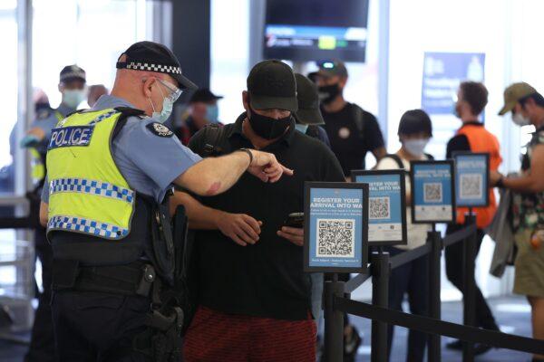 Arriving passengers scan the arrival registration QR codes at the Qantas Domestic terminal in Perth, Australia, on Feb. 5, 2022.  (Paul Kane/Getty Images)