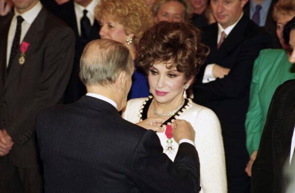 Italian movie star Gina Lollobrigida received the Legion of Honor from the hands of French President Francois Mitterrand during a ceremony at the Elysee Palace in Paris on Feb. 17, 1993. (Laurent Rebours/AP Photo)