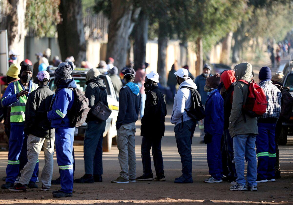Job seekers stand outside a construction site ahead of the release of the unemployement numbers by Statistics South Africa, in Eikenhof, south of Johannesburg, South Africa, on June 23, 2020. (Siphiwe Sibeko/Reuters)