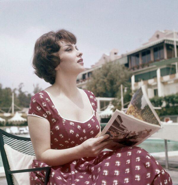 Actress Gina Lollobrigida reads a magazine as she sits by the pool during her stay at the Beverly Hills hotel in Los Angeles, Calif., on May 10, 1959. (AP Photo)