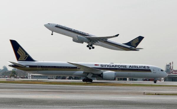 A Singapore Airlines Airbus A330-300 plane takes off behind a Boeing 787-10 Dreamliner at Changi Airport in Singapore on March 28, 2018. (Edgar Su/Reuters)