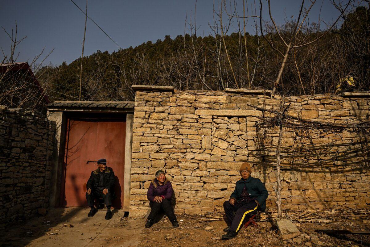 Elderly people sitting in front of a house in a rural area in Tai'an, Shandong Province, China, on Jan. 7, 2023. (Noel Celis/AFP via Getty Images)