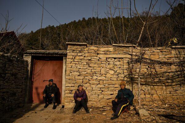 Elderly people sitting in front of a house in a rural area in Tai'an in China's eastern Shandong Province on Jan. 7, 2023. (Noel Celis/AFP via Getty Images)