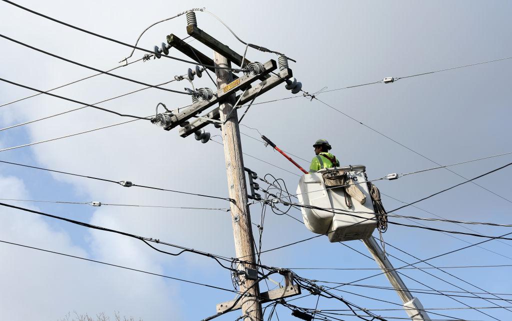 Utility workers make repairs to electrical wires in Guerneville, Calif., on on Jan. 9, 2023. (Justin Sullivan/Getty Images)