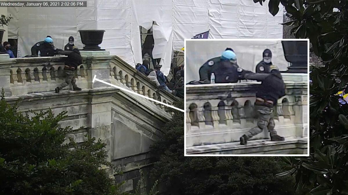 A police officer pushes protester Derrick Vargo off a landing at the U.S. Capitol on Jan. 6, 2021. (U.S. Capitol Police/Screenshot via The Epoch Times)