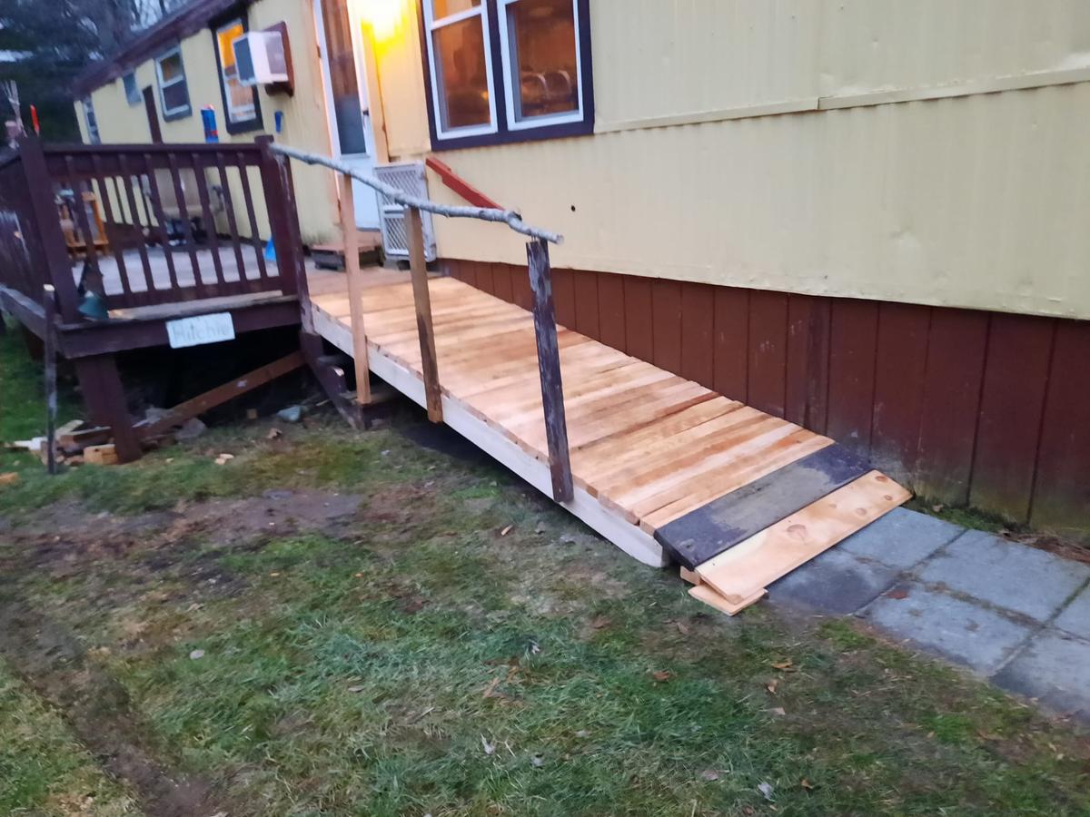 The family volunteered to make this wooden ramp for a woman who had just returned from rehab. (Courtesy of Trevor Michaud)