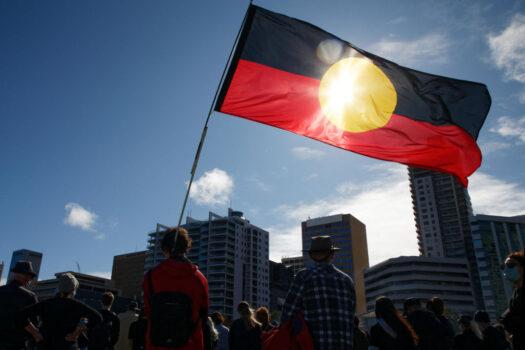 An Aboriginal flag is held aloft during a Black Lives Matter protest to express solidarity with U.S. protesters and demand an end to Aboriginal deaths in custody in Perth, Australia, on June 13, 2020. (Trevor Collens/AFP via Getty Images)
