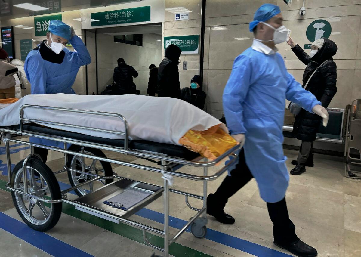 Hospital workers wheel a body on a gurney in the busy emergency room at a hospital in Beijing, China, on Jan. 2, 2023. (Getty Images)