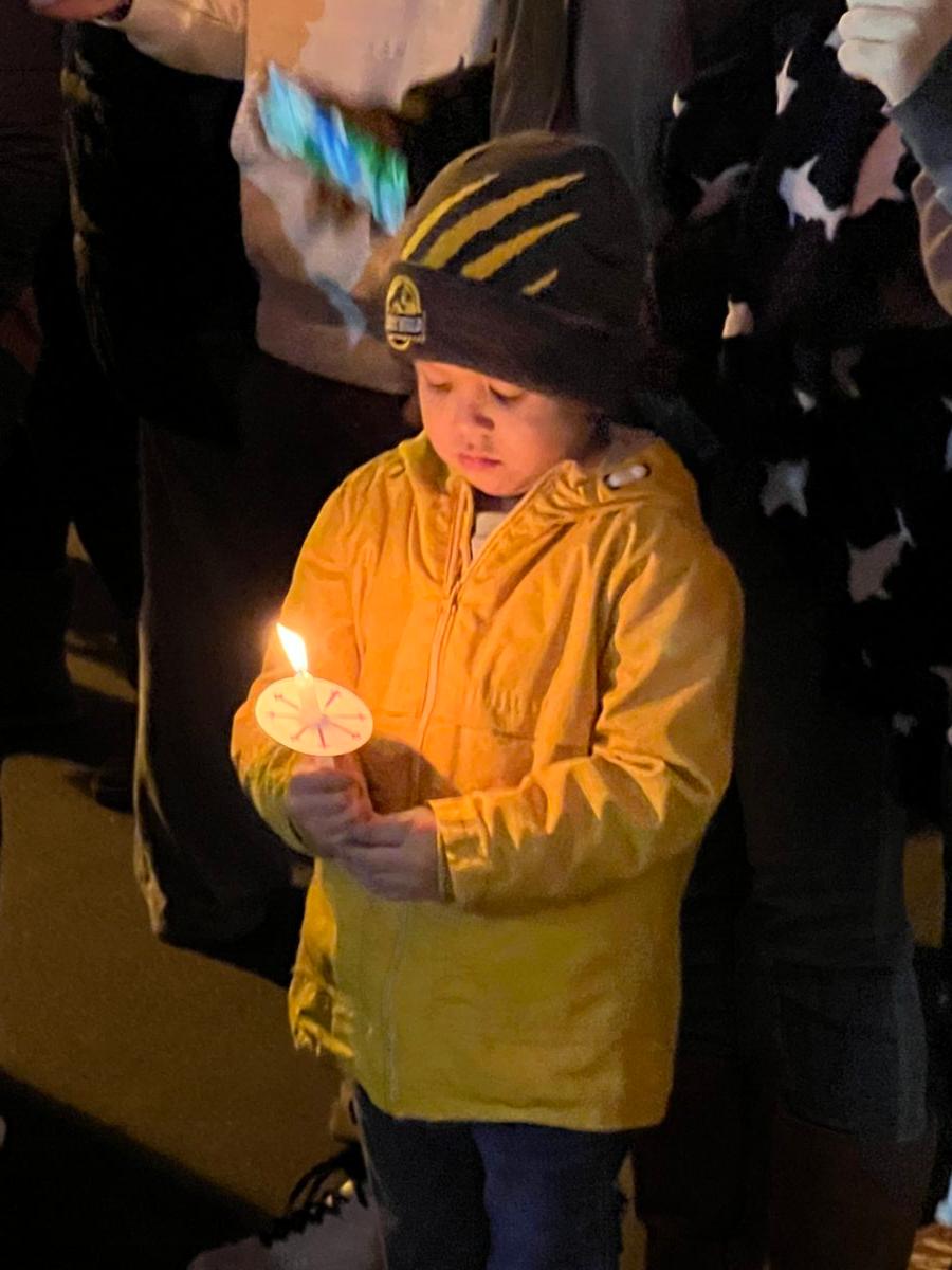 Xavier Anaya holds a candle at a vigil for slain Riverside County Sheriff’s Deputy Darnell Calhoun at the sheriff’s department’s station in Lake Elsinore, Calif., on Jan. 17, 2023. (Brad Jones/The Epoch Times)