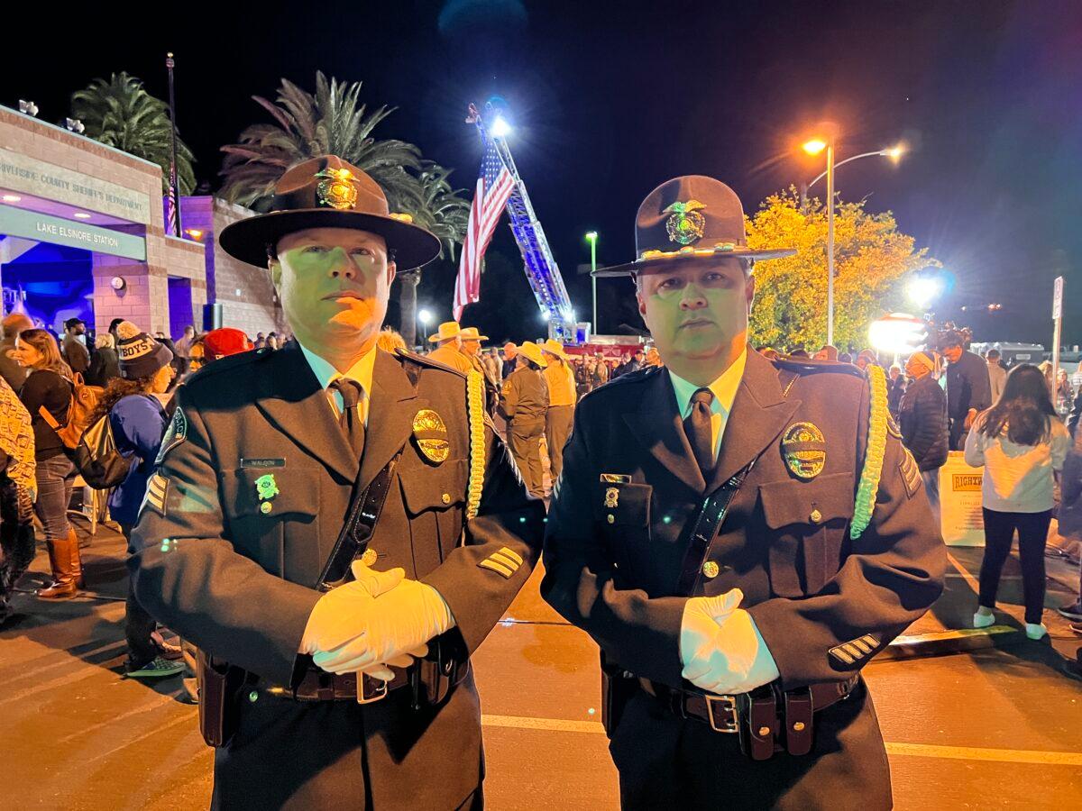 Sgt. Jesse Waldon (L) and Sgt. Jesse Marquez of the Corona Police Department attend a candlelight vigil for slain Riverside County Sheriff’s Deputy Darnell Calhoun in Lake Elsinore, Calif. on Jan. 17, 2023. (Brad Jones/The Epoch Times)